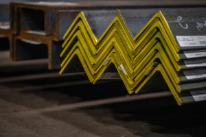 Steel angles stacked on top of each other with the ends painted yellow.