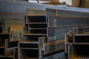 Close up view of steel beams stacked on top of each other in a warehouse