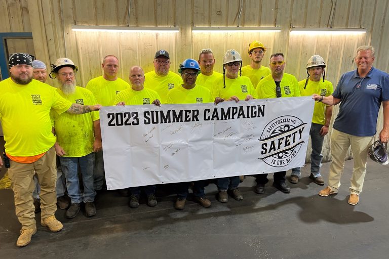 A group of men holding a sign that reads 2023 summer safety campaign on independence day