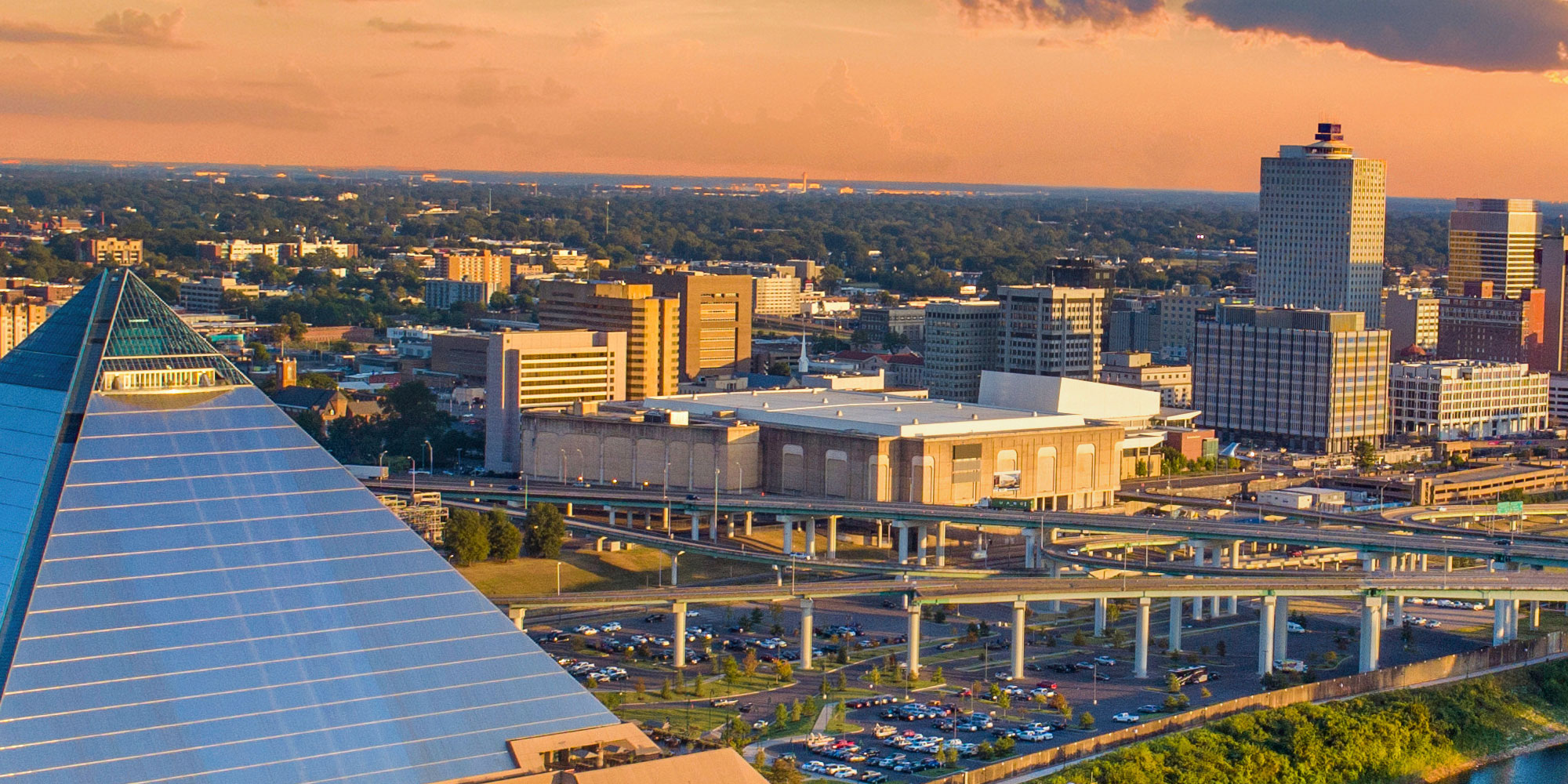 Aerial view of the skyline and memphis pyramid at sunset.