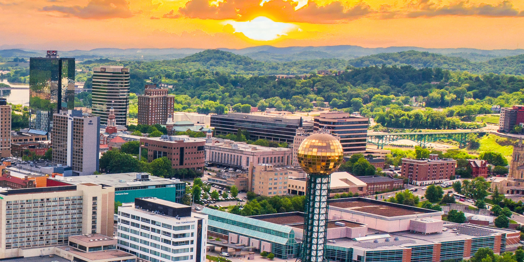 Aerial view of downtown Knoxville, Tennessee skyline at sunset.
