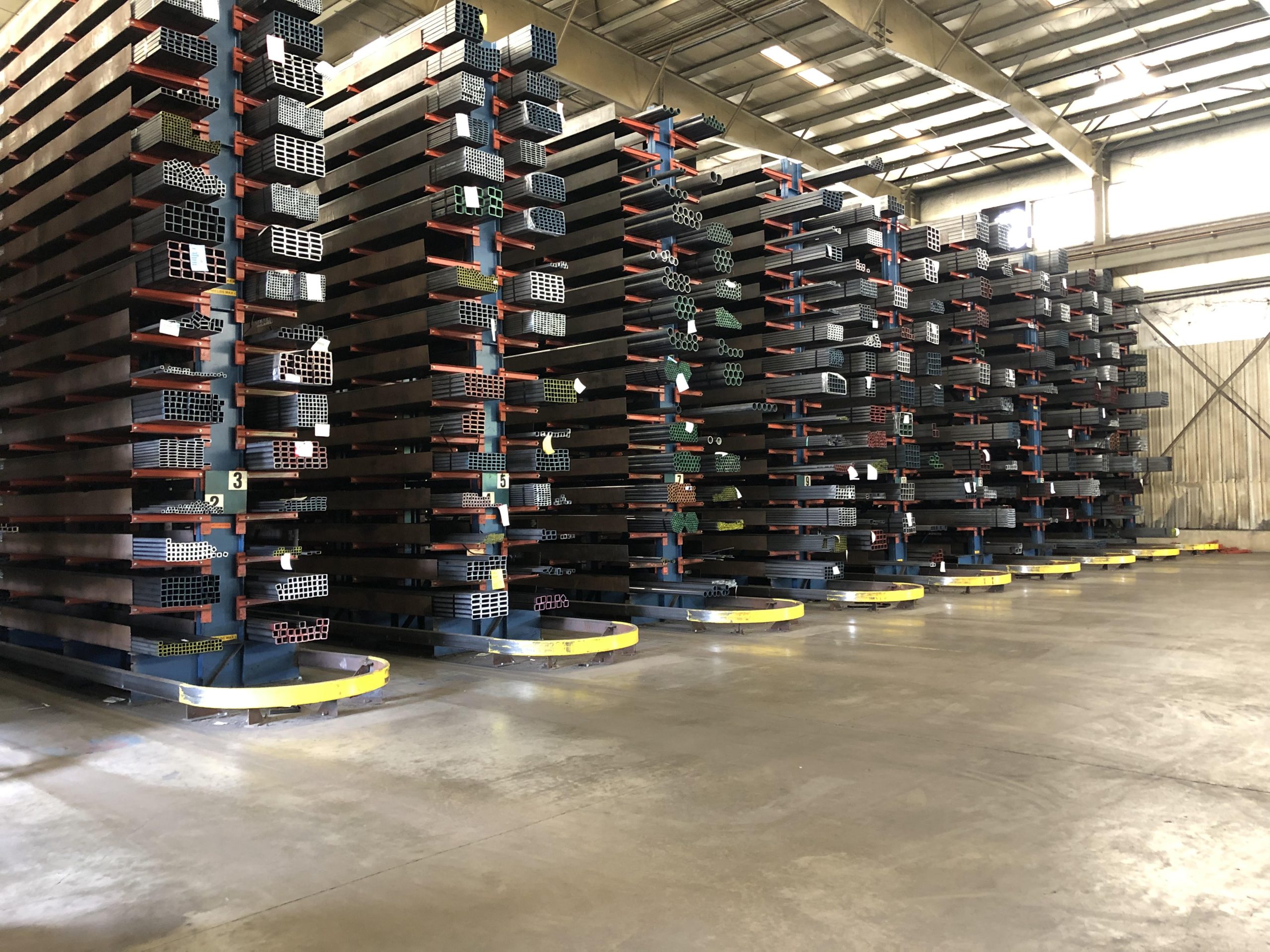 Storage racks filled with steel products inside of a warehouse