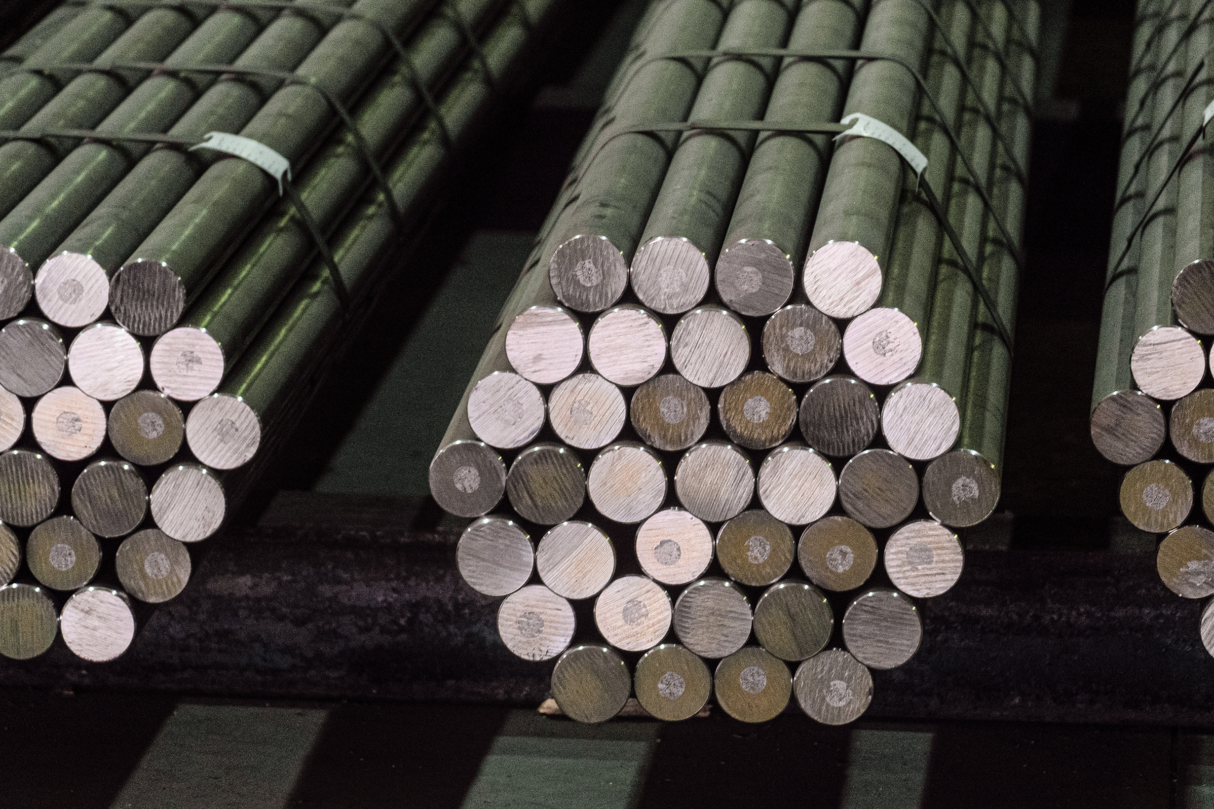 rolled cold round bars stacked in a hexagon shape banded together with wire ties