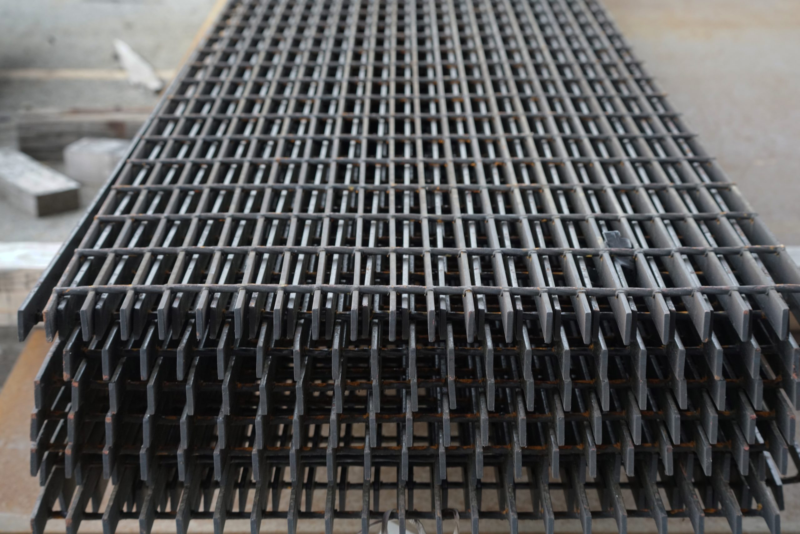 One large stack of bar grating laying on top of each other