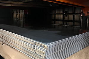 Aluminum sheet stack sitting on a wooden palette in a tower for metal storage with brown paper separating each sheet